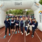 Gruppenfoto von sieben Mitarbeitenden der ARGE Krebs in Laufkleidung vor dem Start des Bochumer Brustkrebslaufs 2025.